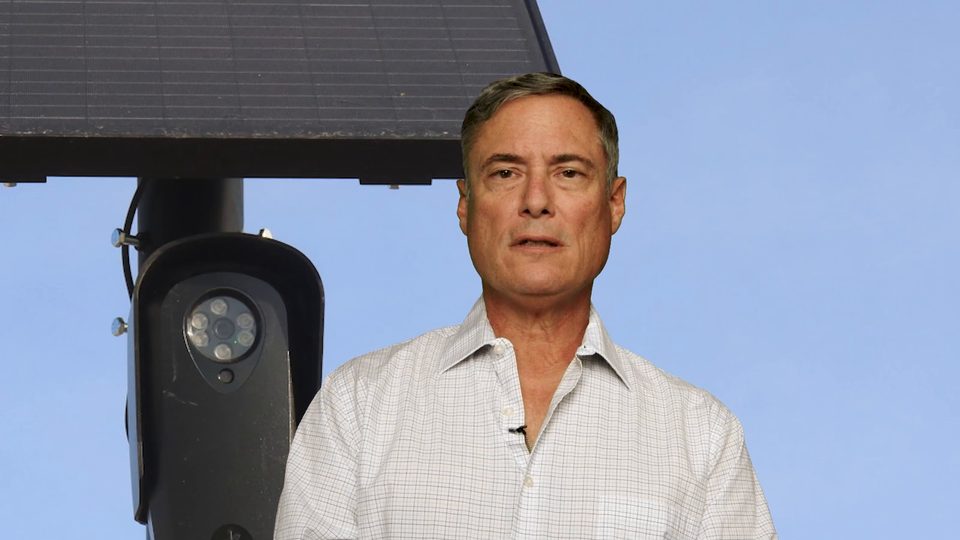 Todd Balash beside a license-plate camera